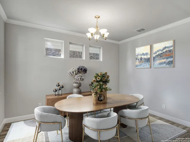 a view of a dining room with furniture and chandelier