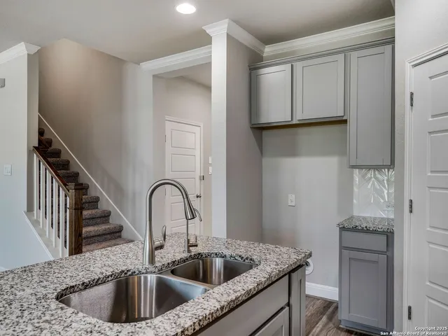 a kitchen with a sink and cabinets
