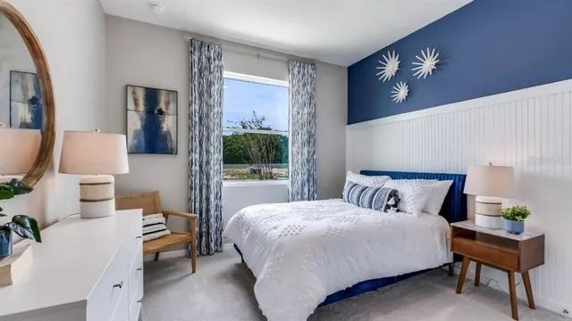 a bedroom with a large bed and a chandelier