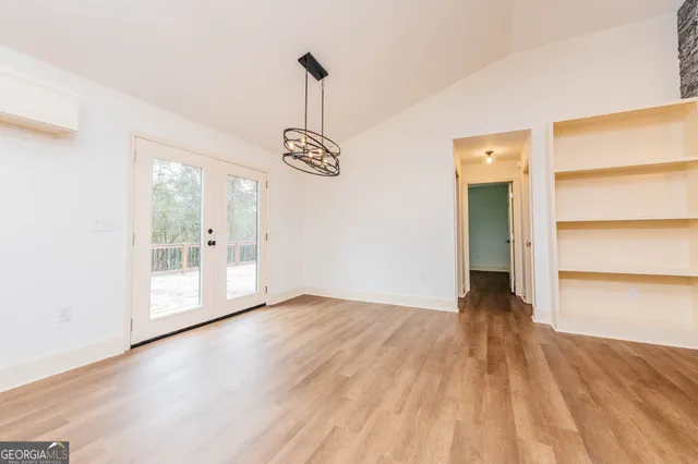 a kitchen with granite countertop a sink cabinets and stainless steel appliances