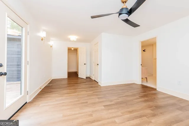 a view of a kitchen with stainless steel appliances granite countertop a sink and a wooden floor