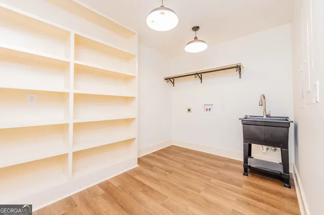 a view of a room with wooden floor ceiling fan