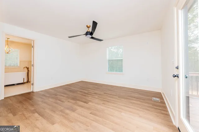 a bathroom with a tub sink and mirror