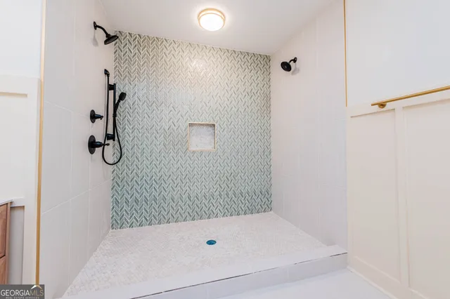 a bathroom with a tub and a shower
