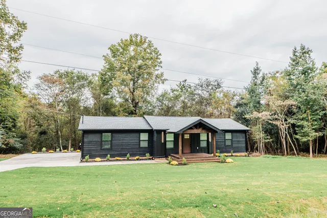 an aerial view of a house with a yard