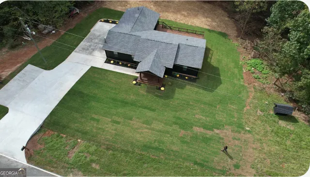 a front view of a house with a yard and trees