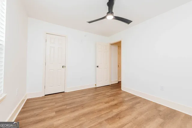 a view of a house with a big yard and potted plants