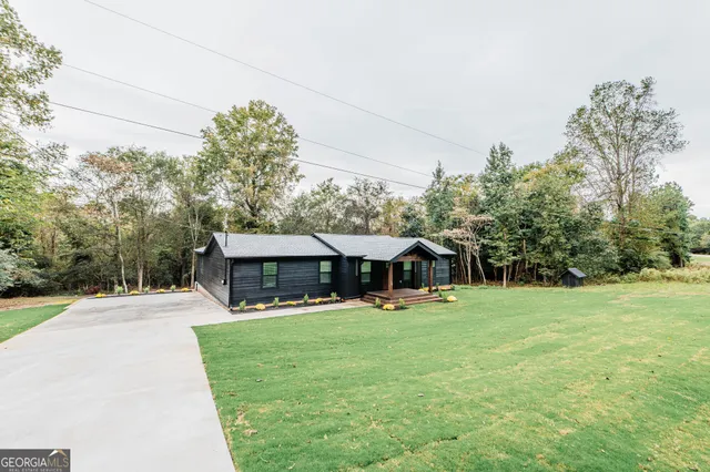 a backyard of a house with a wooden deck