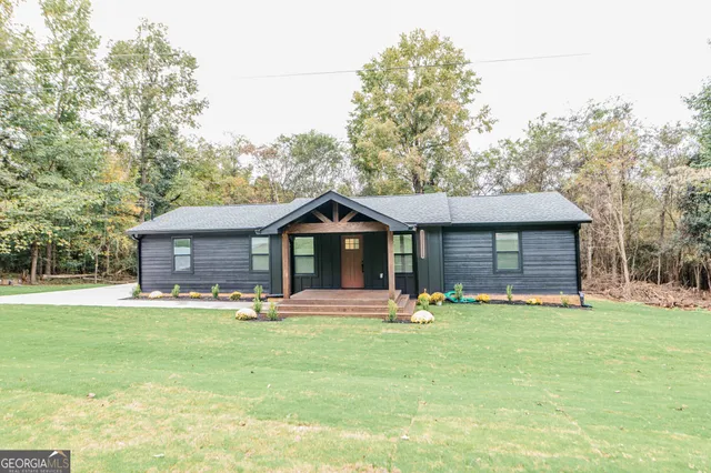 a big house with a yard and large trees