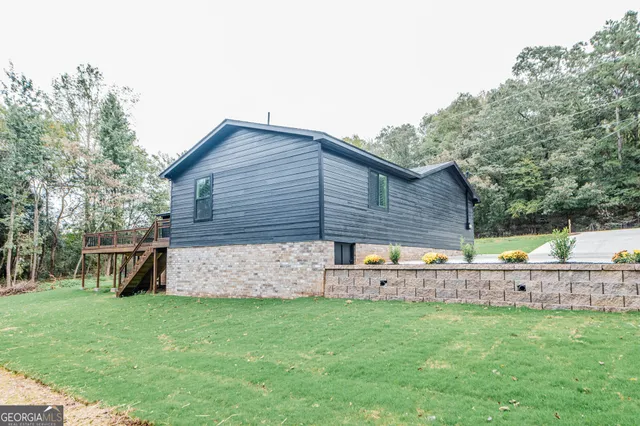 a front view of a house with a garden