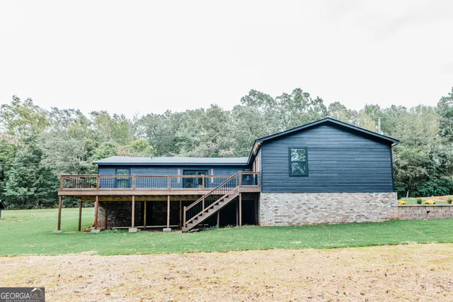 a view of empty room with wooden floor and fireplace