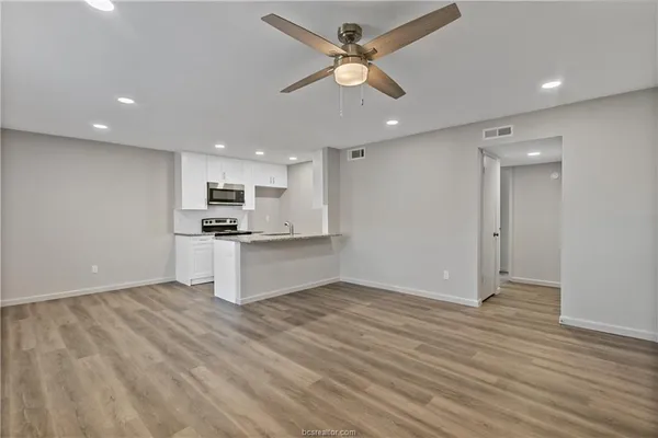 a kitchen with stainless steel appliances granite countertop a stove and a sink