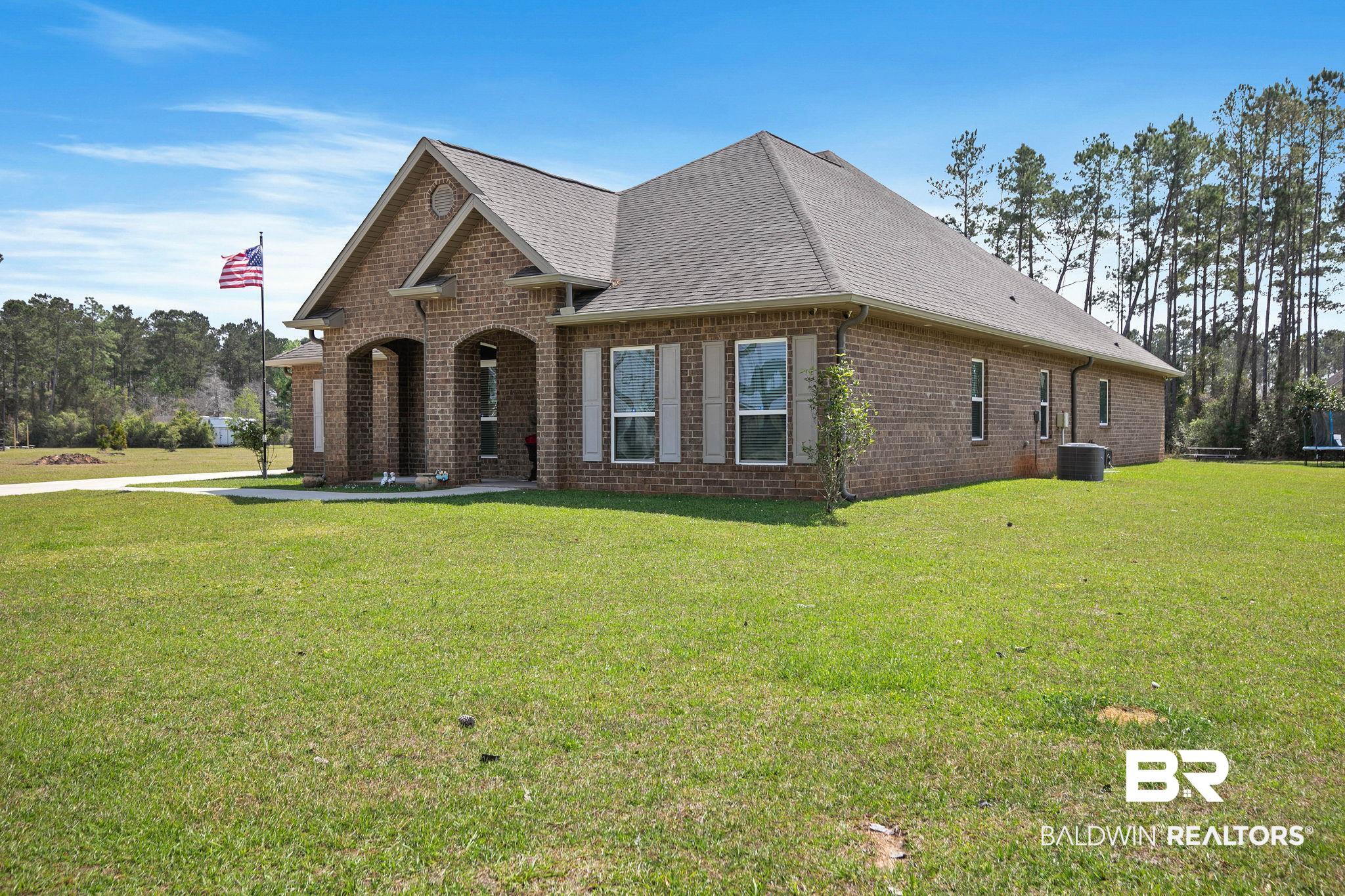 12750 B Jenkins Pit Road Daphne, AL 36527 - Photo 80 of 89 View of front of house with brick siding, a front lawn, and a shingled roof