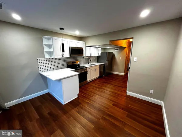 a kitchen with a sink appliances cabinets and a counter top space