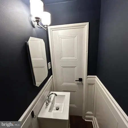 a bathroom with a sink a mirror and vanity