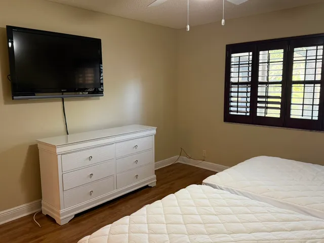 an aerial view of residential houses with outdoor space and trees
