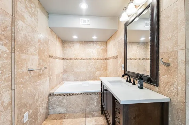 a bathroom with a sink a mirror and a bathtub