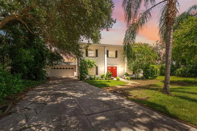 a view of a house with a yard and tree s