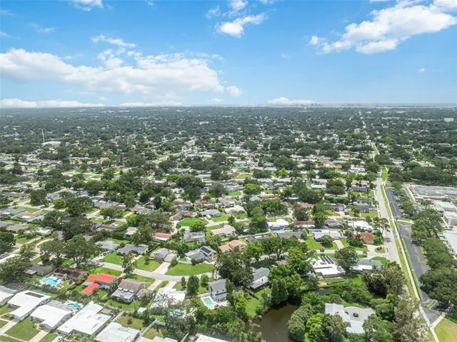 an aerial view of residential houses with city view