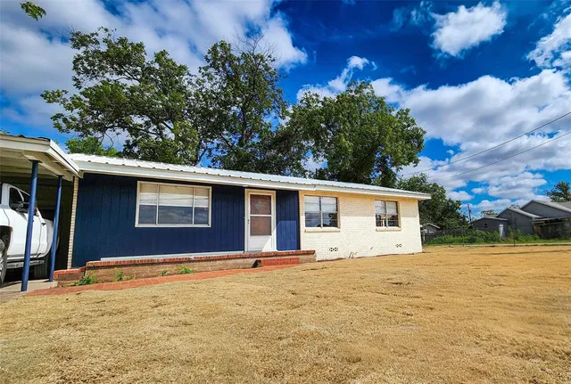 a house with trees in the background