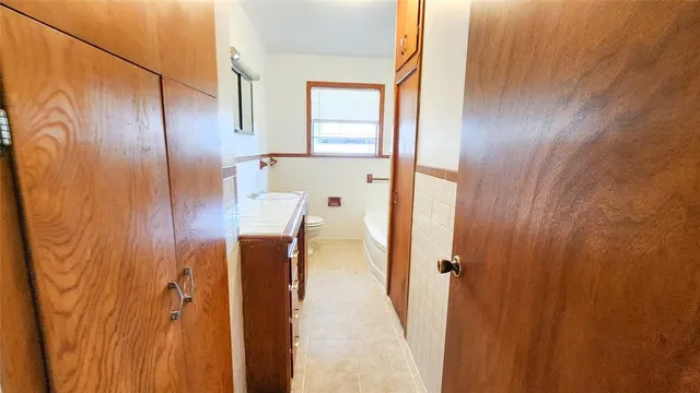 a bathroom with a granite countertop shower and a sink
