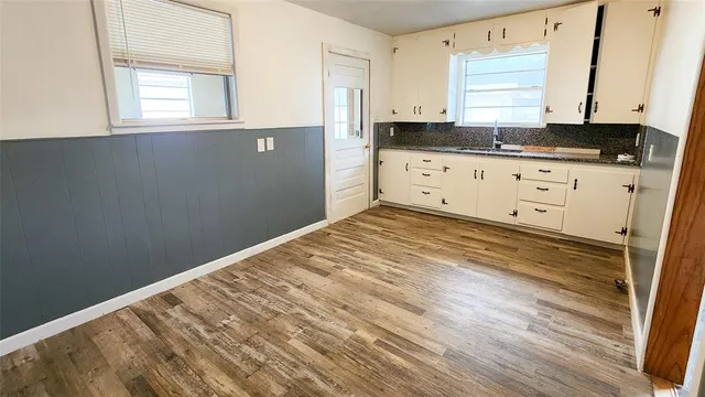 a view of kitchen with granite countertop cabinets