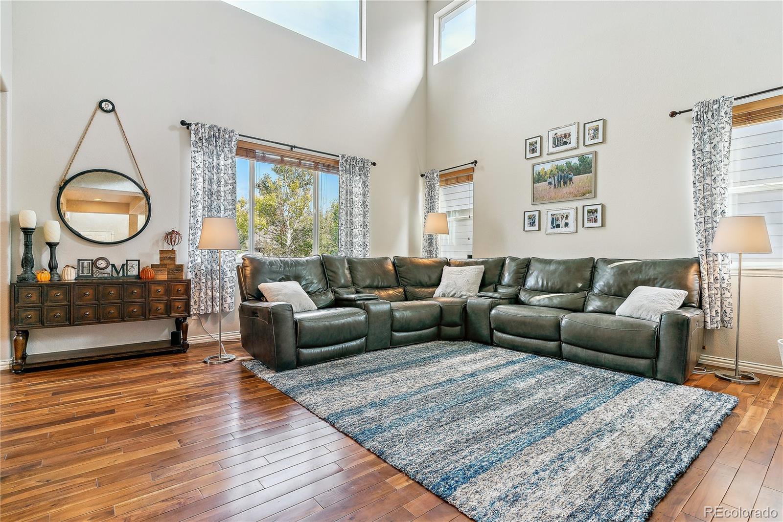 3477 Softwind Point Castle Rock, CO 80108 - Photo 11 of 50 a living room with furniture and a fireplace