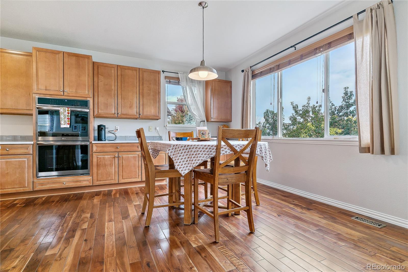 3477 Softwind Point Castle Rock, CO 80108 - Photo 15 of 50 a dining room with furniture window wooden floor
