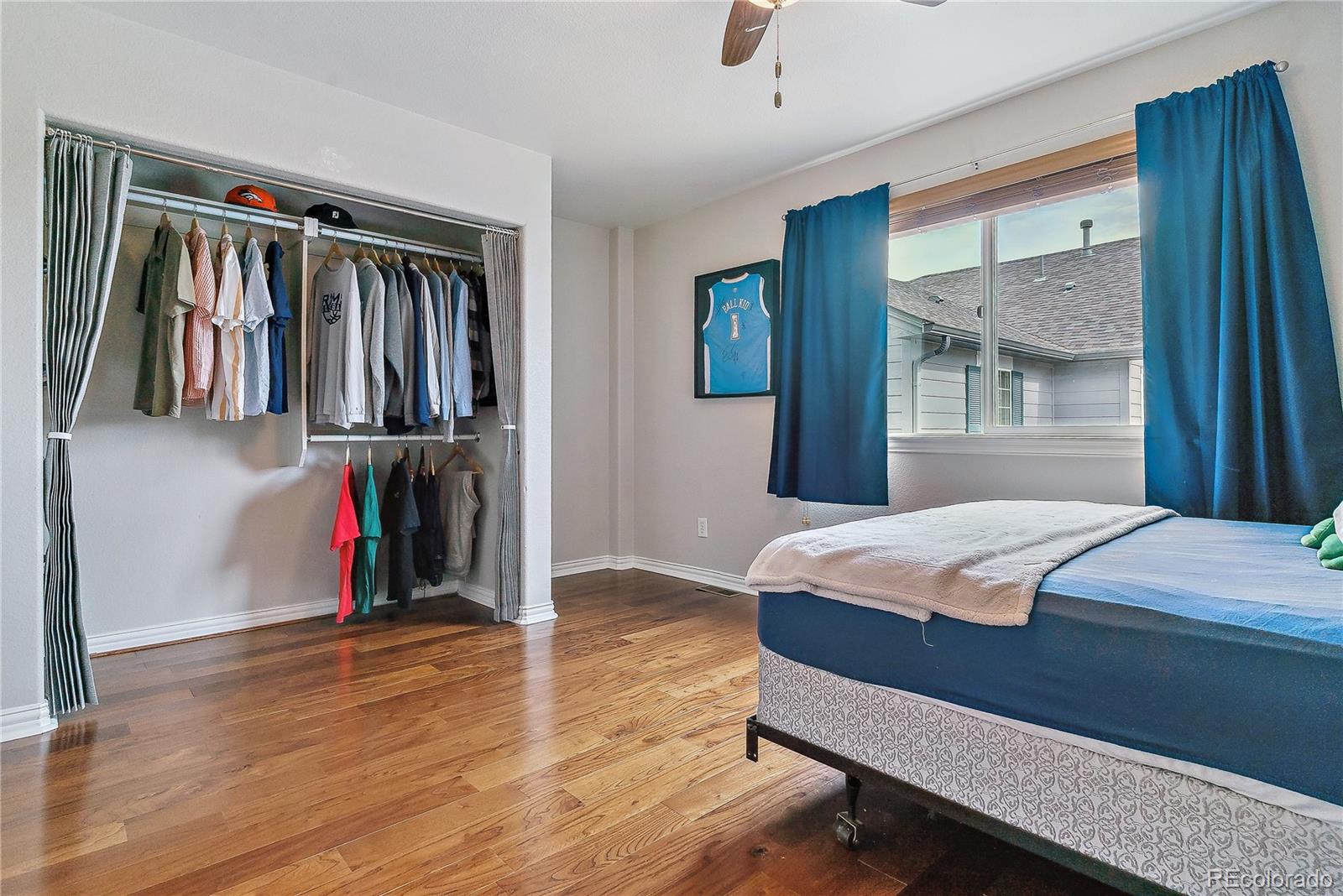3477 Softwind Point Castle Rock, CO 80108 - Photo 25 of 50 a bedroom with a bed and a window