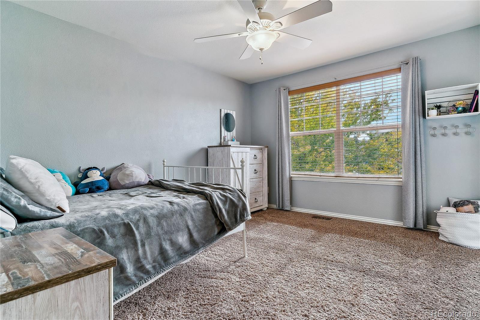 3477 Softwind Point Castle Rock, CO 80108 - Photo 26 of 50 a bed sitting in a bedroom next to a window