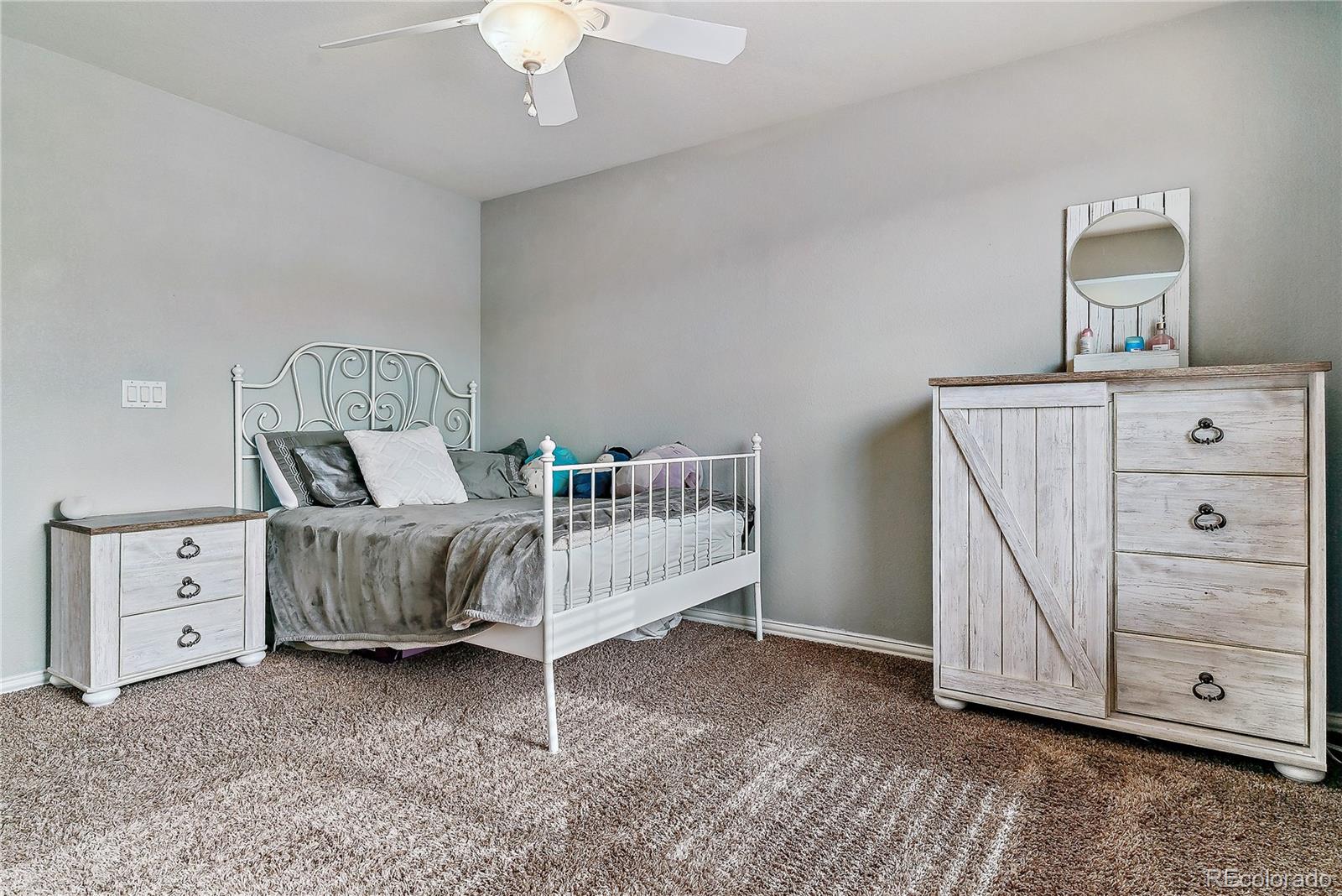 3477 Softwind Point Castle Rock, CO 80108 - Photo 27 of 50 a bedroom with a bed and a dresser