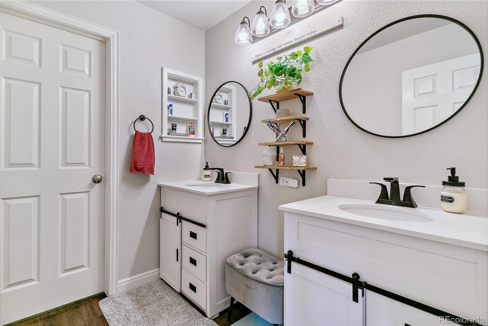 3477 Softwind Point Castle Rock, CO 80108 - Photo 30 of 50 a bathroom with a sink and a mirror