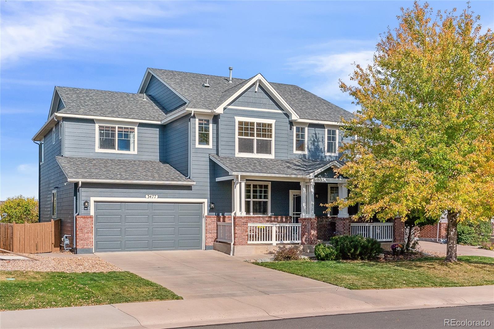 3477 Softwind Point Castle Rock, CO 80108 - Photo 3 of 50 a front view of a house with a yard and garage