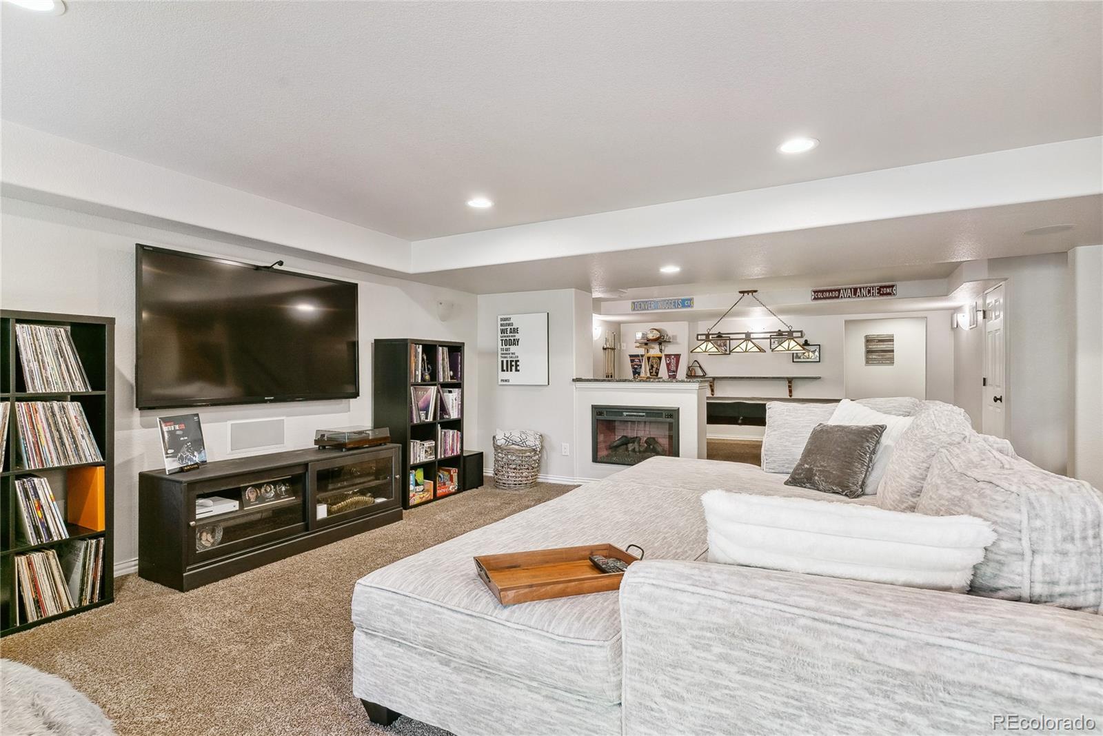 3477 Softwind Point Castle Rock, CO 80108 - Photo 32 of 50 a living room with furniture and a flat screen tv
