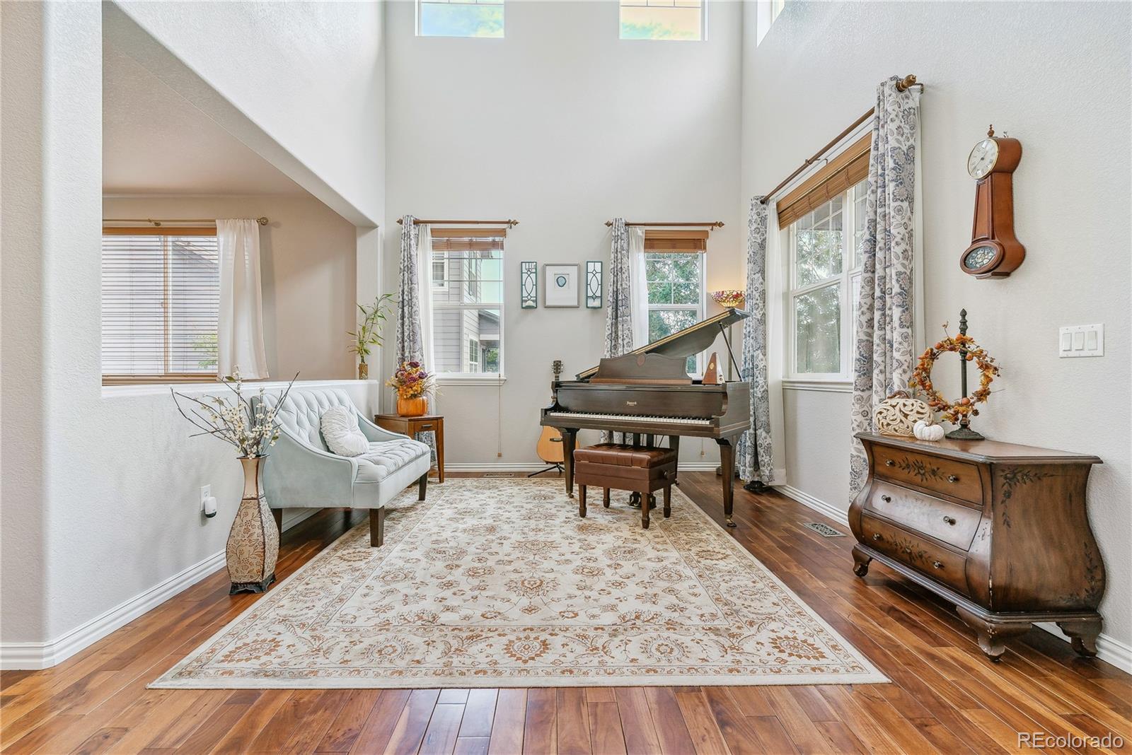 3477 Softwind Point Castle Rock, CO 80108 - Photo 5 of 50 a living room with furniture and wooden floor