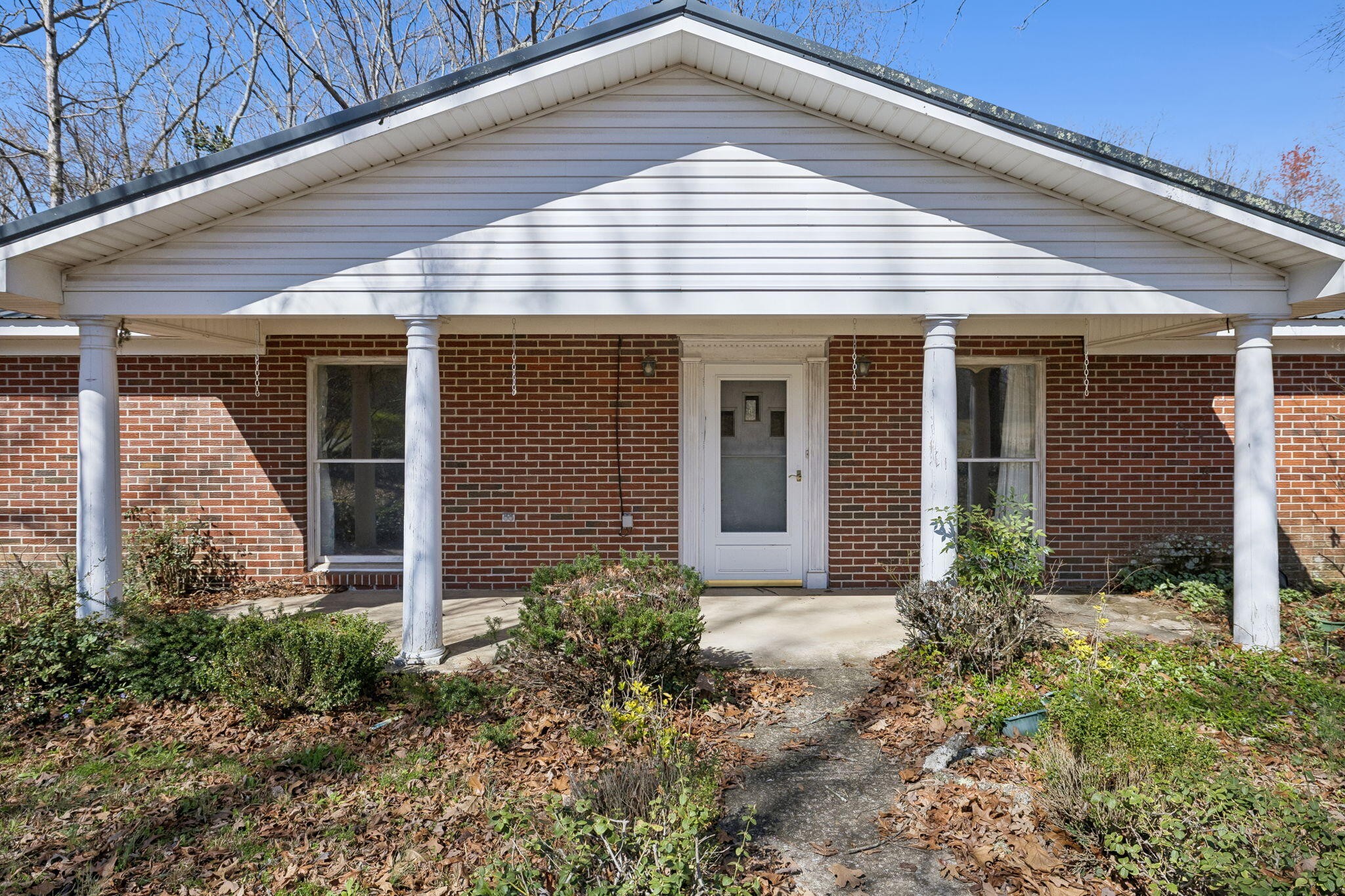 766 Bowling Alley Road Manchester, TN 37355 - Photo 2 of 57 a view of a white house with potted plants next to a yard