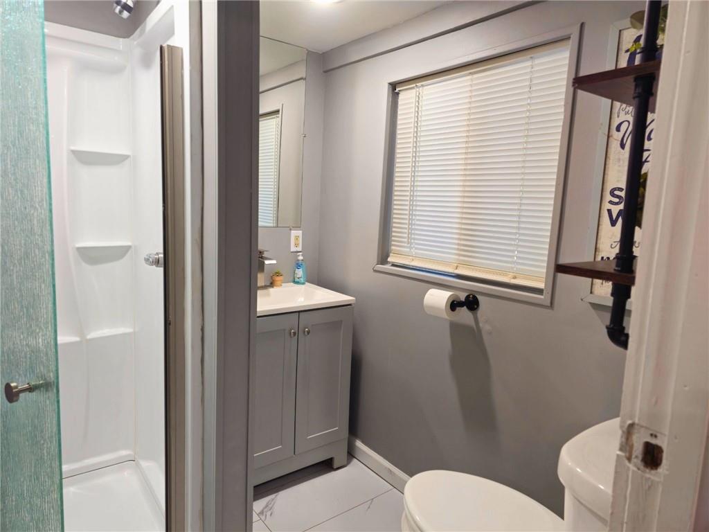 1088 Burns Road Kennerdell, PA 16374 - Photo 17 of 49 a bathroom with a toilet a sink and a mirror