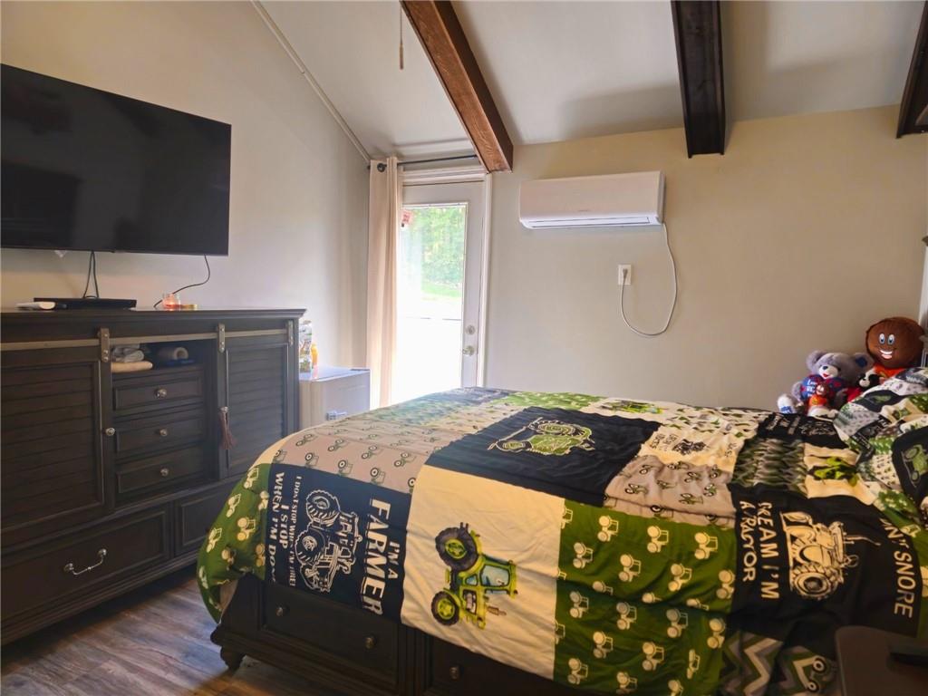 1088 Burns Road Kennerdell, PA 16374 - Photo 32 of 49 a bedroom with a bed and a flat tv screen on dresser
