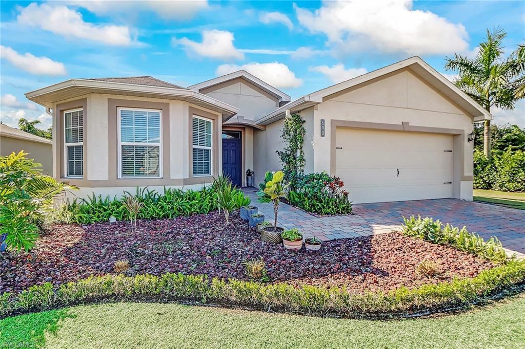 690 Hadley Place East Naples, FL 34104 - Photo 1 of 27 a view of a house with a garden