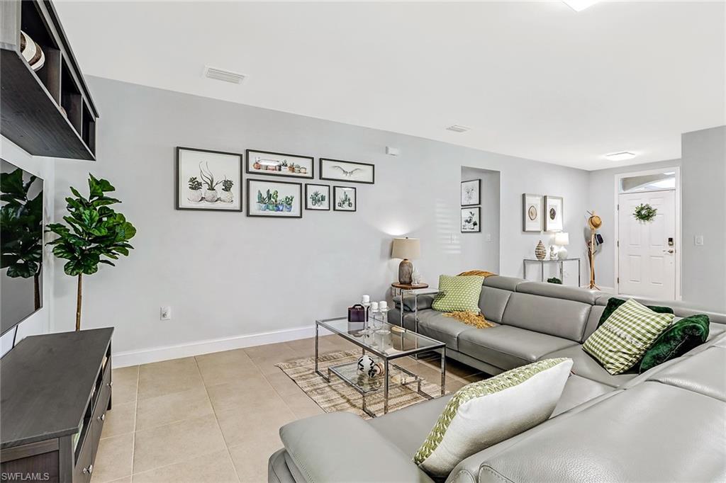 690 Hadley Place East Naples, FL 34104 - Photo 12 of 27 a living room with furniture and a potted plant