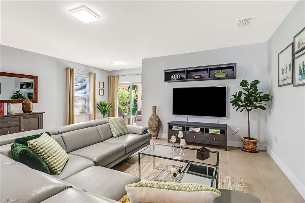 690 Hadley Place East Naples, FL 34104 - Photo 13 of 27 a living room with furniture and a flat screen tv