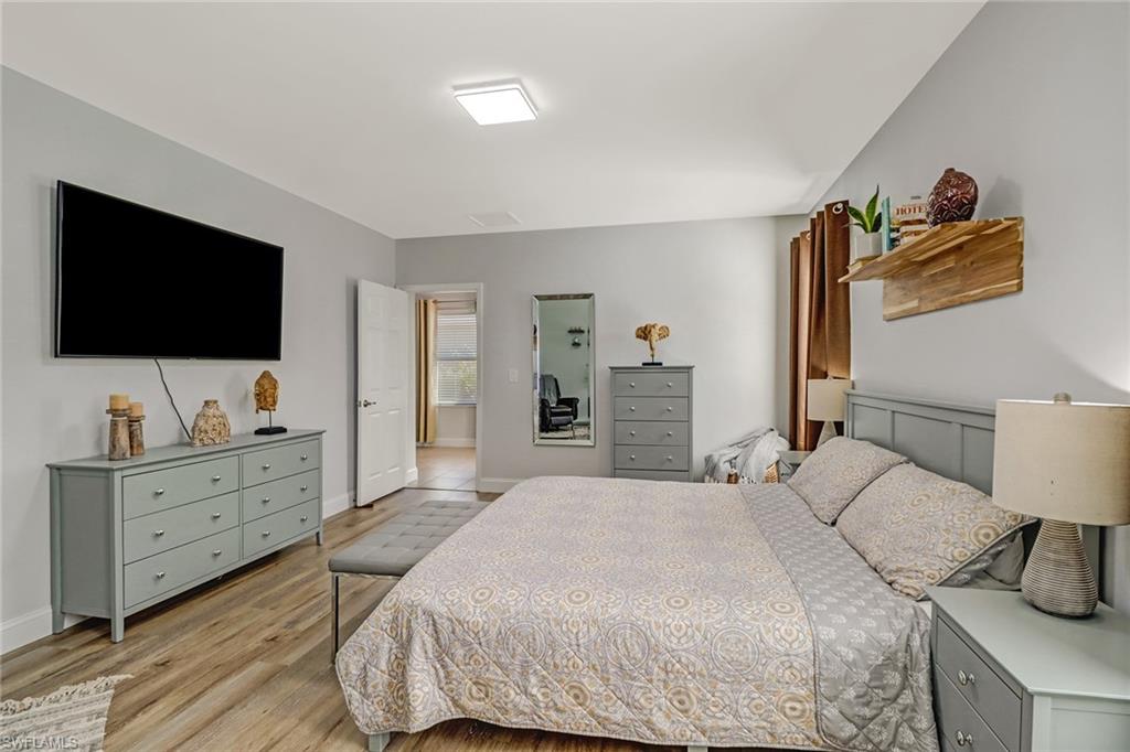690 Hadley Place East Naples, FL 34104 - Photo 15 of 27 a bedroom with a bed and a flat screen tv