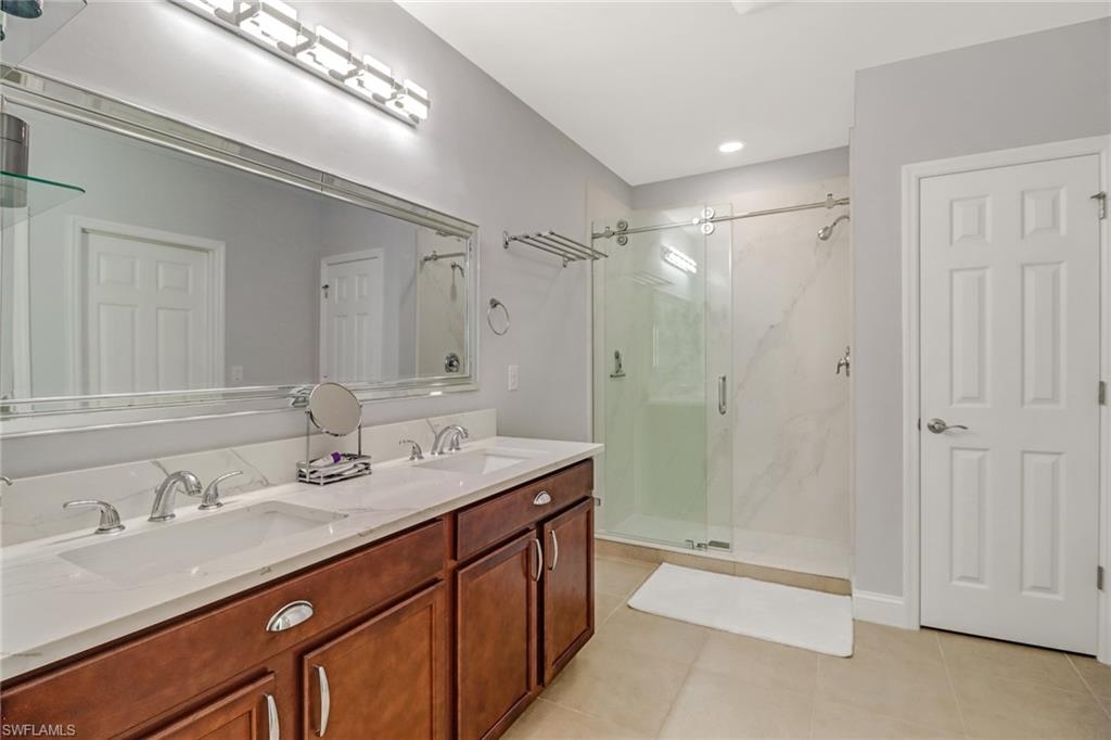 690 Hadley Place East Naples, FL 34104 - Photo 16 of 27 a bathroom with a granite countertop sink mirror and double