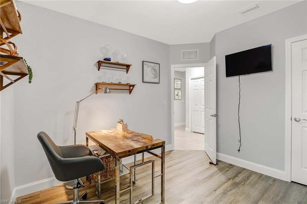 690 Hadley Place East Naples, FL 34104 - Photo 18 of 27 a view of a workspace with furniture and wooden floor