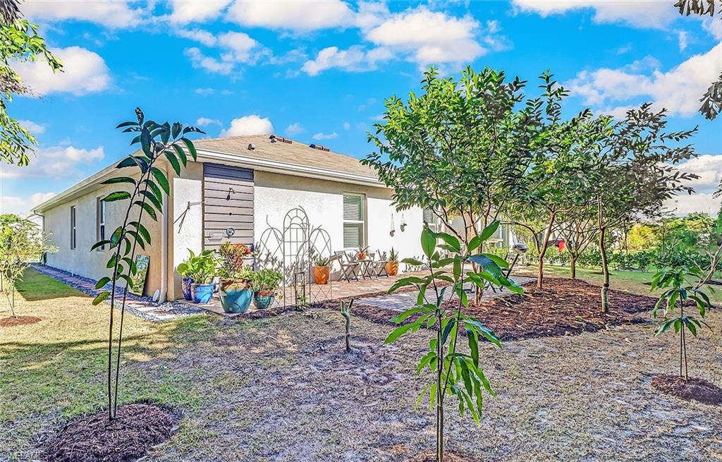 690 Hadley Place East Naples, FL 34104 - Photo 24 of 27 a view of a house with backyard and sitting area