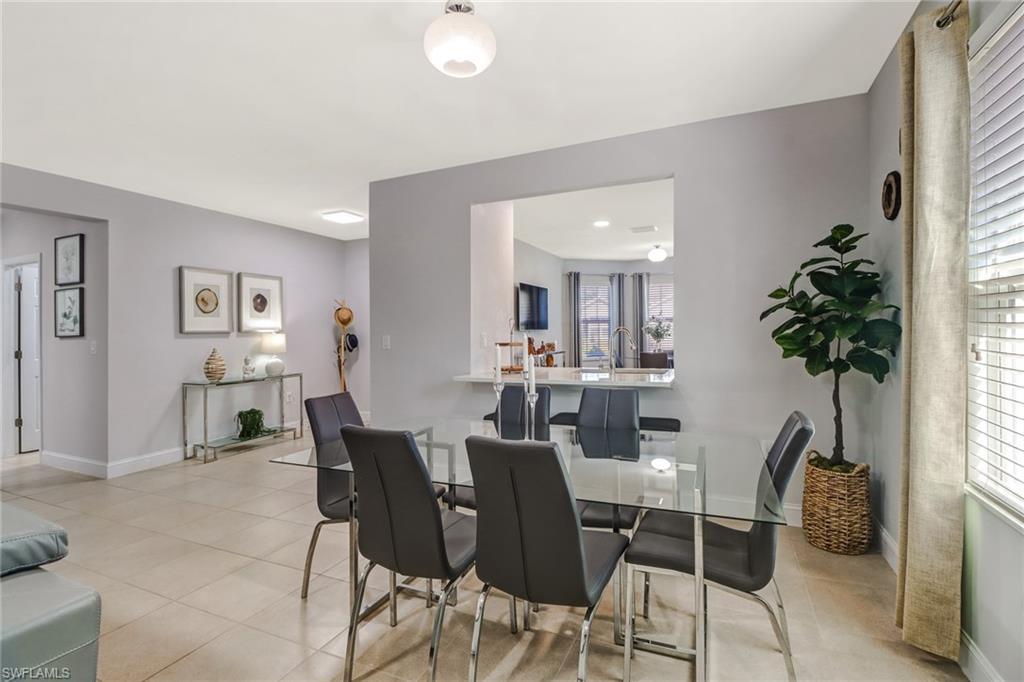 690 Hadley Place East Naples, FL 34104 - Photo 5 of 27 a view of a dining room with furniture and a potted plant