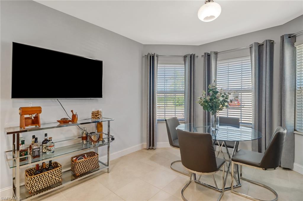 690 Hadley Place East Naples, FL 34104 - Photo 9 of 27 a living room with furniture and a flat screen tv