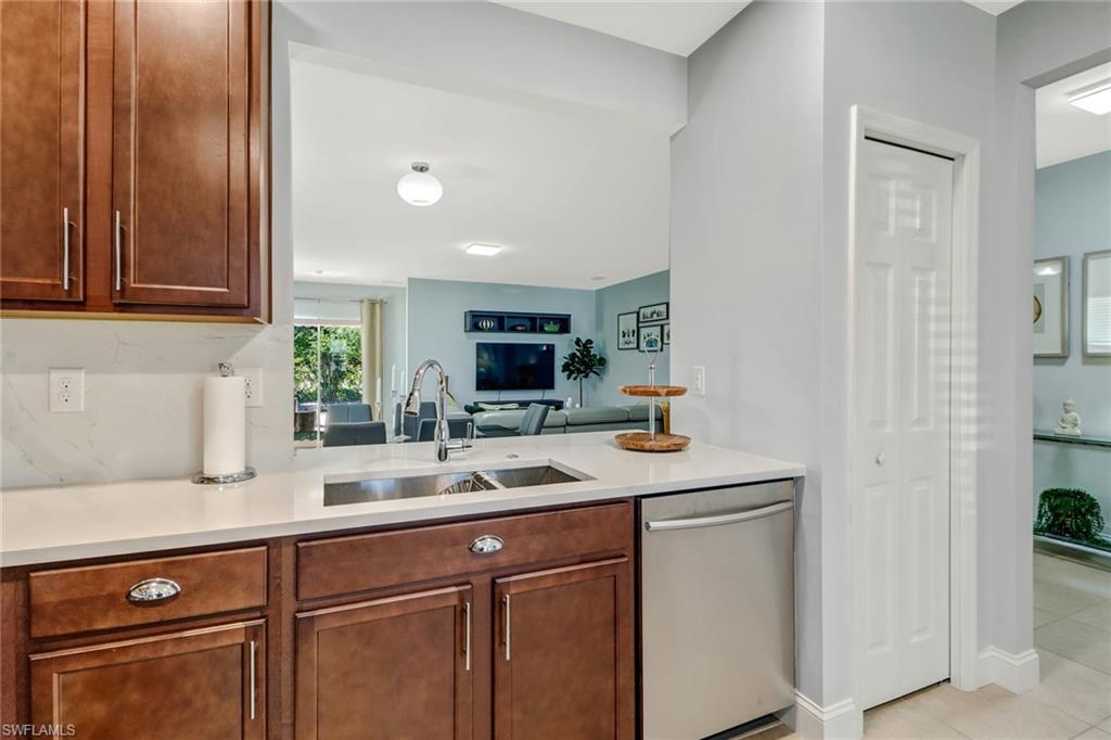 690 Hadley Place East Naples, FL 34104 - Photo 10 of 27 a kitchen with a sink and cabinets