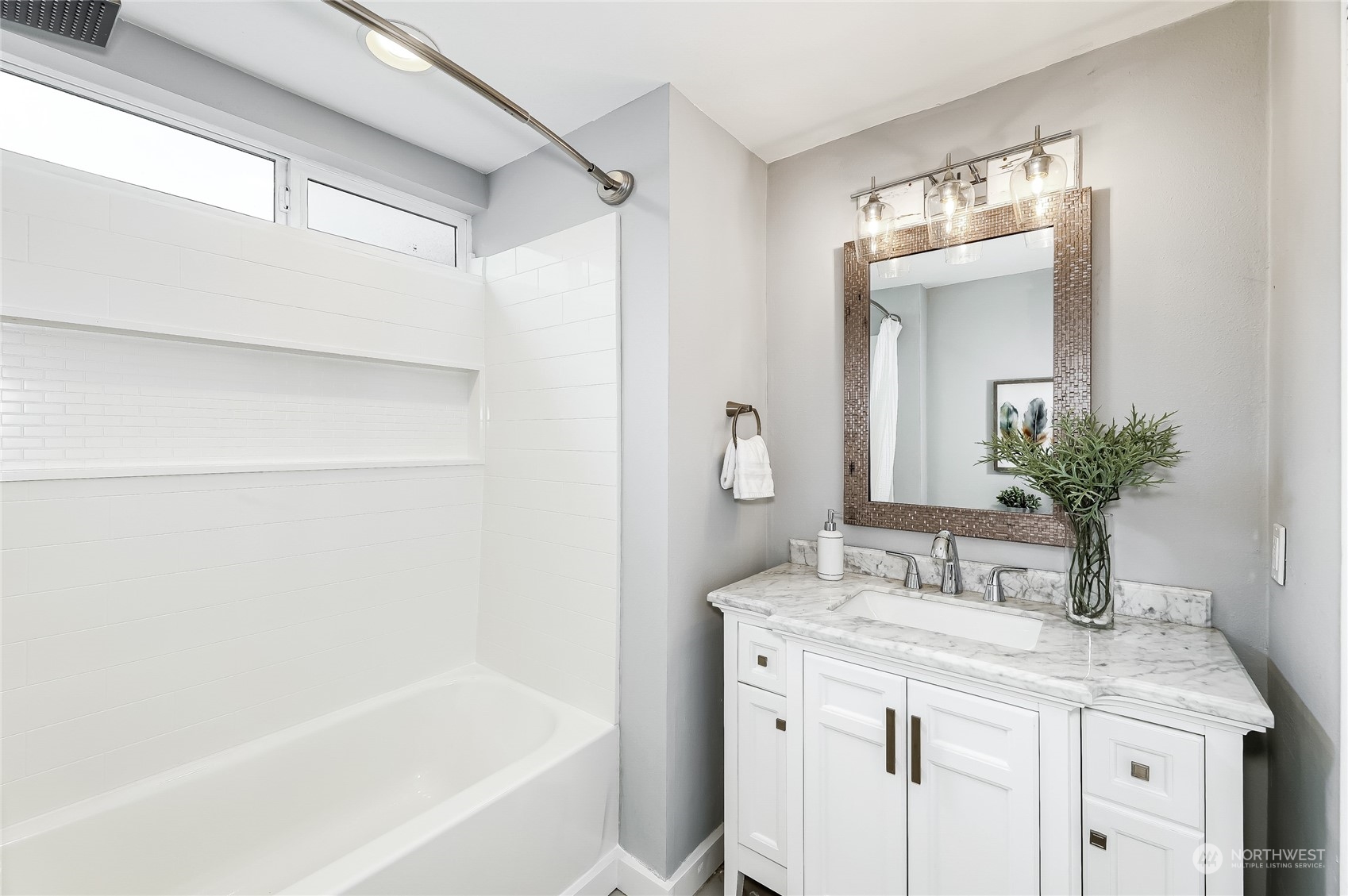 365 Northwest 47th Street Seattle, WA 98107 - Photo 16 of 31 a bathroom with a granite countertop sink a mirror and a bathtub