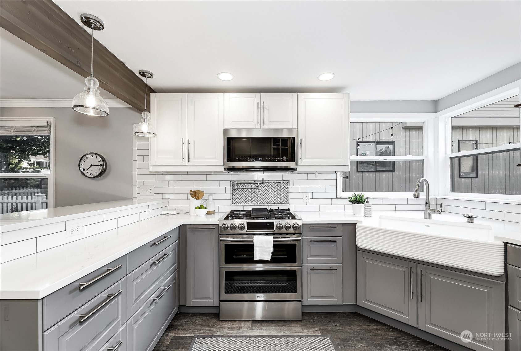 365 Northwest 47th Street Seattle, WA 98107 - Photo 4 of 31 a kitchen with stainless steel appliances a stove sink microwave and cabinets